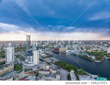 Yekaterinburg city and pond aerial panoramic view at summer sunset. Yekaterinburg city and pond aerial panoramic view at summer sunset. 104227015