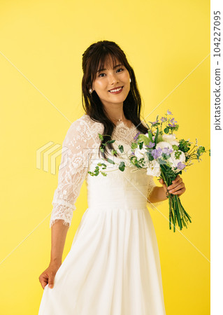 A woman in a wedding dress, a bride with a bouquet A woman in a wedding dress, a bride with a bouquet 104227095