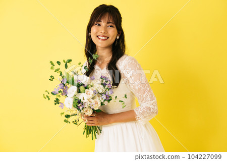 A woman in a wedding dress, a bride with a bouquet A woman in a wedding dress, a bride with a bouquet 104227099