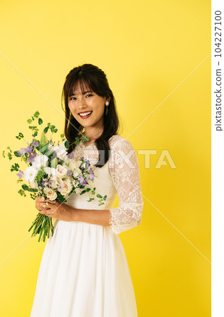 A woman in a wedding dress, a bride with a bouquet A woman in a wedding dress, a bride with a bouquet 104227100