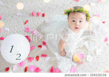 Half birthday 6 month old baby wearing a baby dress Half birthday 6 month old baby wearing a baby dress 104228116