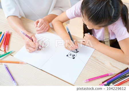 Parents and children playing and drawing in the room 104229612