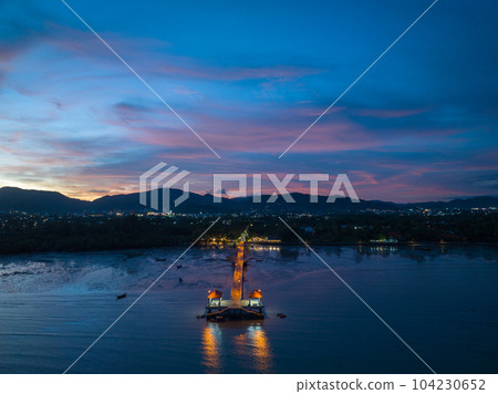 aerial photography cloud above Palai pier at beautiful sunset..Palai pier is next to Chalong pier..fishing boats parking on the beach..colorful cloud above the mountain range background.. aerial photography cloud above Palai pier at beautiful sunset..Palai pier is next to Chalong pier..fishing boats parking on the beach..colorful cloud above the mountain range background.. 104230652