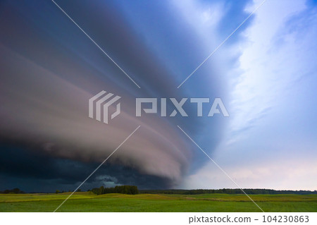 Angry supercell storm influenced by Climate change. Dangerous storm supercell shelf cloud with layers. Angry supercell storm influenced by Climate change. Dangerous storm supercell shelf cloud with layers. 104230863