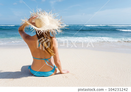 Woman lies on the white sand on the beach Woman lies on the white sand on the beach 104231242