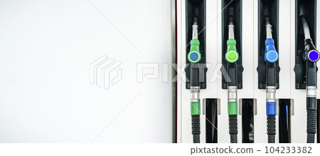 Gas station. Pistols with gasoline and diesel fuel at a car gas station. Oil business and transportation costs 104233382