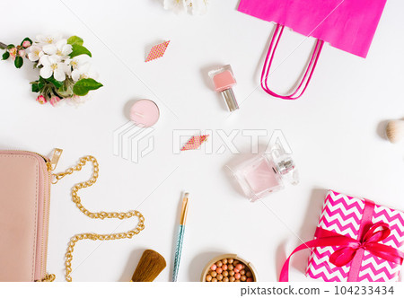 Concept of a beauty blog. Accessories for women's makeup and delicate apple blossoms on a white background. Flat apartment, top view, women's desk, workplace Concept of a beauty blog. Accessories for women's makeup and delicate apple blossoms on a white background. Flat apartment, top view, women's desk, workplace 104233434