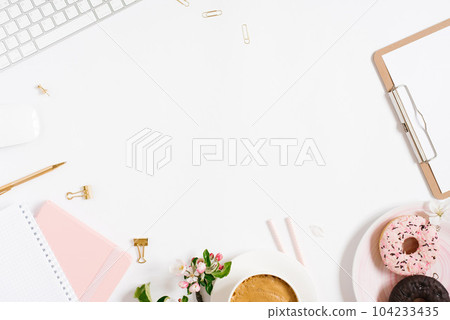 Flat lay home office workspace female blogger background with white modern keyboard, notebook, cup of coffee, donut and apple flowers, copy space on white background Flat lay home office workspace female blogger background with white modern keyboard, notebook, cup of coffee, donut and apple flowers, copy space on white background 104233435