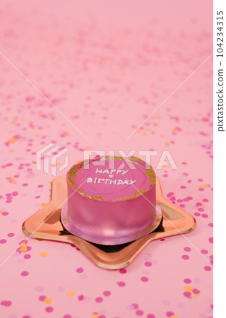 Trendy pink birthday bento cake on a golden plate in the shape of a star on a pink background with confetti Trendy pink birthday bento cake on a golden plate in the shape of a star on a pink background with confetti 104234315