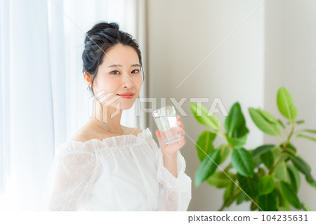 Young woman drinking water Young woman drinking water 104235631
