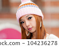 Asian American Woman in beanie cap 104236278