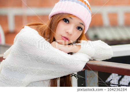 Asian American Woman in beanie cap 104236284