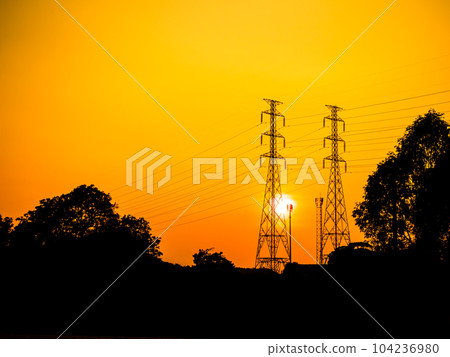 High voltage pole on Sunset Background,Line Power Utility Tower Electric Voltage Transmission Energy Station Distribution,Electrician Grid Post Tower Danger Technology Construction Industry Plant. High voltage pole on Sunset Background,Line Power Utility Tower Electric Voltage Transmission Energy Station Distribution,Electrician Grid Post Tower Danger Technology Construction Industry Plant. 104236980