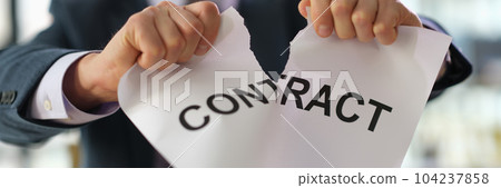Businessman in suit tearing paper document contract at work in office closeup Businessman in suit tearing paper document contract at work in office closeup 104237858