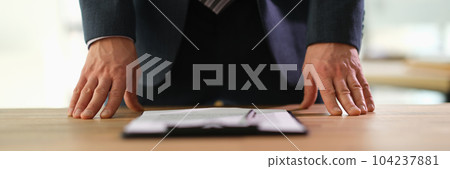 Manager standing at table with documents at business conference closeup Manager standing at table with documents at business conference closeup 104237881