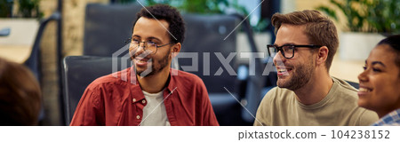 Group of young and happy diverse multi ethnic business people analyzing project results while working together in modern office or coworking space. Group of young and happy diverse multi ethnic business people analyzing project results while working together in modern office or coworking space. 104238152