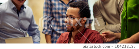 Group of happy multiracial business people looking at laptop screen and discussing work or project results while standing in the modern office or coworking space Group of happy multiracial business people looking at laptop screen and discussing work or project results while standing in the modern office or coworking space 104238153