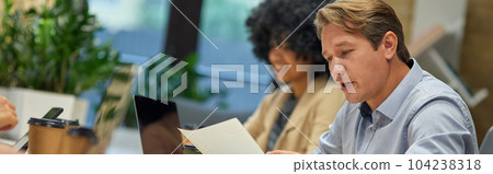 Two diverse coworkers working together in the modern office Two diverse coworkers working together in the modern office 104238318