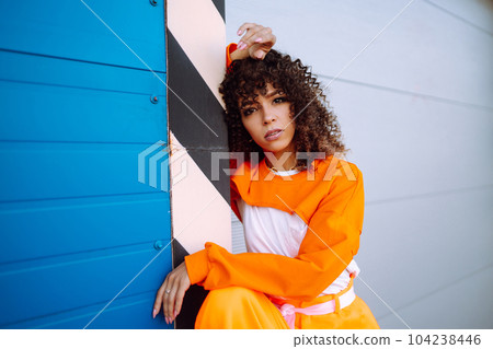 African American woman - dancer dancing in the street at sunset. Sport, dancing and urban culture concept. Fashion lifestyle. African American woman - dancer dancing in the street at sunset. Sport, dancing and urban culture concept. Fashion lifestyle. 104238446