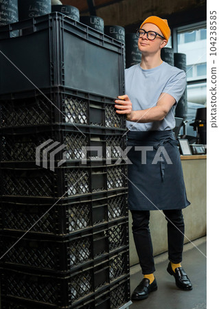 Barista accepts new batch of coffee unpacking boxes, preparing for working process in coffee shop. Barista accepts new batch of coffee unpacking boxes, preparing for working process in coffee shop. 104238585