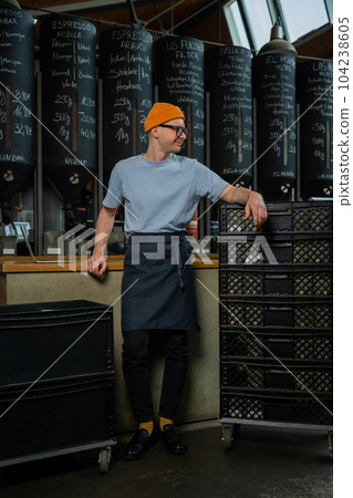 Barista accepts new batch of coffee unpacking boxes, preparing for working process in coffee shop. Barista accepts new batch of coffee unpacking boxes, preparing for working process in coffee shop. 104238605