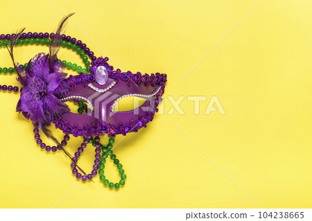 Mardi gras concept. Congratulation card with violet mask on yellow background Top view 2023 Mardi Gras Parade Schedule Mockup Copy space. Mardi gras concept. Congratulation card with violet mask on yellow background Top view 2023 Mardi Gras Parade Schedule Mockup Copy space. 104238665
