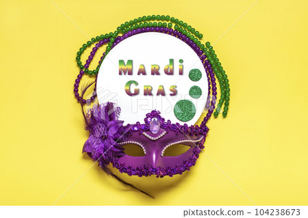Mardi gras concept. Congratulation card with violet mask on yellow background Top view 2023 Mardi Gras Parade Schedule Mockup Copy space. Mardi gras concept. Congratulation card with violet mask on yellow background Top view 2023 Mardi Gras Parade Schedule Mockup Copy space. 104238673