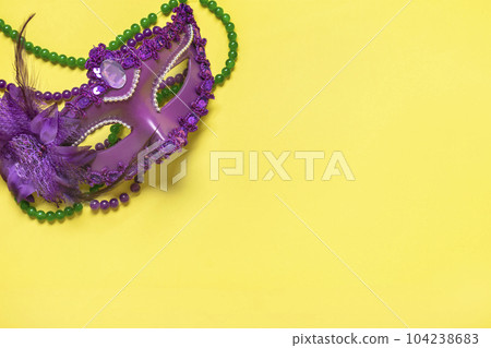 Mardi gras concept. Congratulation card with violet mask on yellow background Top view 2023 Mardi Gras Parade Schedule Mockup Copy space. Mardi gras concept. Congratulation card with violet mask on yellow background Top view 2023 Mardi Gras Parade Schedule Mockup Copy space. 104238683