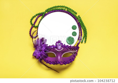Mardi gras lettering. Congratulation card with violet mask on yellow background Top view 2023 Mardi Gras Parade Schedule Mockup Copy space. Mardi gras lettering. Congratulation card with violet mask on yellow background Top view 2023 Mardi Gras Parade Schedule Mockup Copy space. 104238712
