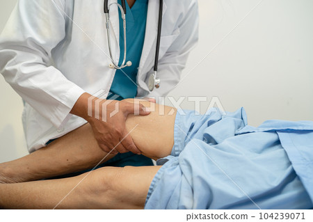 Asian elderly woman patient show her scars surgical total knee joint replacement Suture wound surgery arthroplasty on bed in hospital, healthy strong medical concept. 104239071
