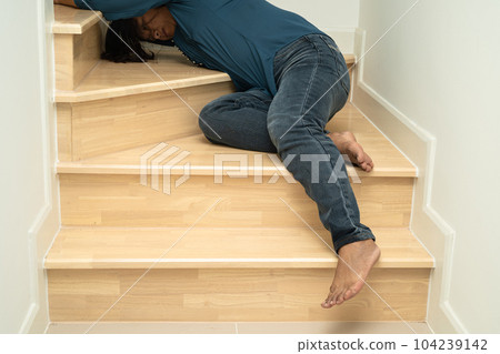 Asian lady fall down the stairs and pain at hip and waist because slippery surfaces. Asian lady fall down the stairs and pain at hip and waist because slippery surfaces. 104239142