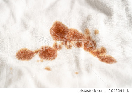 Dirty sauce stain on cloth to wash with washing powder, cleaning housework concept. 104239148