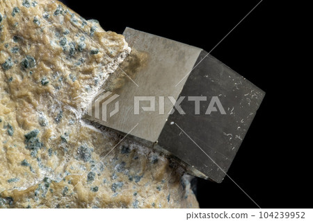 Macro Pyrite mineral stone on black background Macro Pyrite mineral stone on black background 104239952