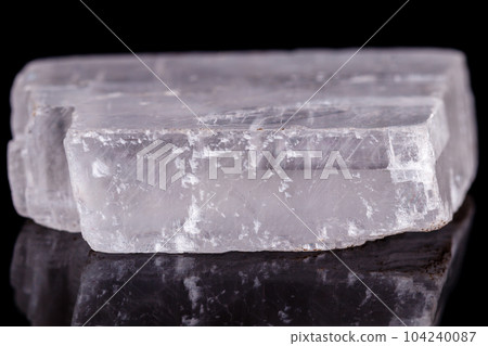 Macro mineral stone Iceland spar on black background Macro mineral stone Iceland spar on black background 104240087