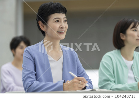 Middle-aged women attending a seminar 104240715