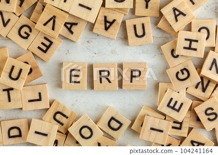 Top down view, pile of square wooden blocks with letters ERP (stands for Enterprise resource planning) on white board. 104241164