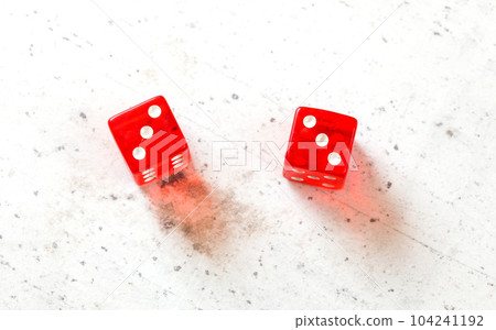 Two red craps dices showing Hard Six (double number three) overhead shot on white board Two red craps dices showing Hard Six (double number three) overhead shot on white board 104241192