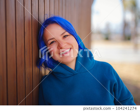 Female wearing light blue oversize hoodie and jeans Female wearing light blue oversize hoodie and jeans 104241274