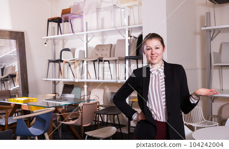 Saleswoman welcoming to chair store Saleswoman welcoming to chair store 104242004