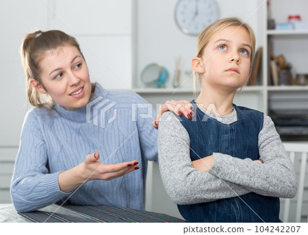 Mother soothes little daughter after an quarrel 104242207