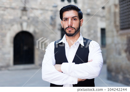 Serious man with arms crossed 104242244