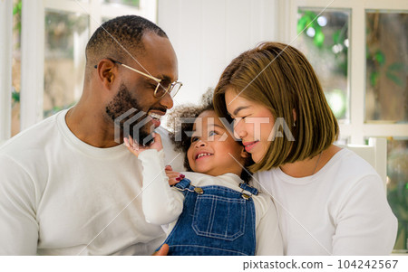 Portrait of happy family father mother and daughter spending vacation 104242567
