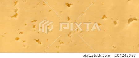 Structure of yellow cheese with holes, background macro. Food backdrop Structure of yellow cheese with holes, background macro. Food backdrop 104242583