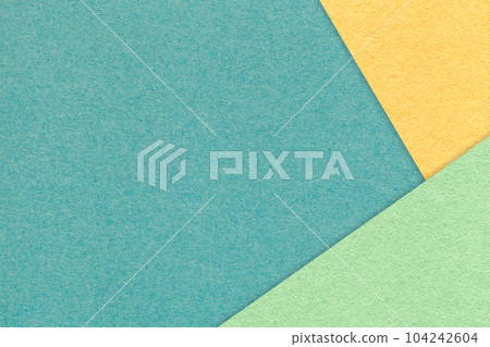 Texture of craft cyan color paper background with yellow and green border. Vintage abstract turquoise cardboard. Texture of craft cyan color paper background with yellow and green border. Vintage abstract turquoise cardboard. 104242604