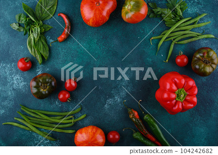Assortment of different tomatoes, pepper and basil 104242682