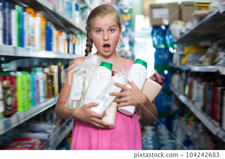 Glad girl holding shampoo and shower gel 104242683