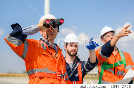 Maintenance engineer technician working outdoor at wind turbine field Maintenance engineer technician working outdoor at wind turbine field 104242738