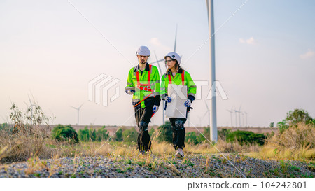 Professional engineer technician working outdoor at wind turbine field Professional engineer technician working outdoor at wind turbine field 104242801