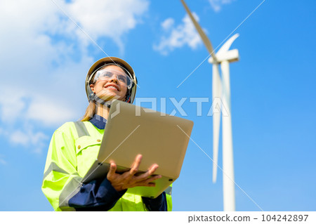 Renewable energy engineer working on wind turbine 104242897
