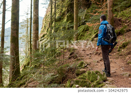 Traveler Man with backpack mountaineering Travel Lifestyle concept mountains on background Summer trip vacations outdoor. Concept of travel and healthy, active lifestyle. Young guy with dreadlocks Traveler Man with backpack mountaineering Travel Lifestyle concept mountains on background Summer trip vacations outdoor. Concept of travel and healthy, active lifestyle. Young guy with dreadlocks 104242975